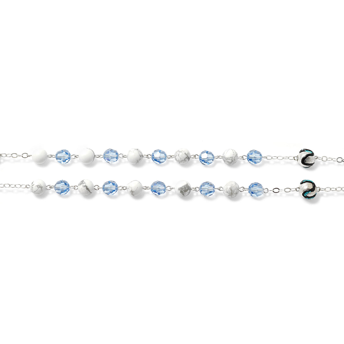 Silver bracelet with blue and clear beads on a white background
