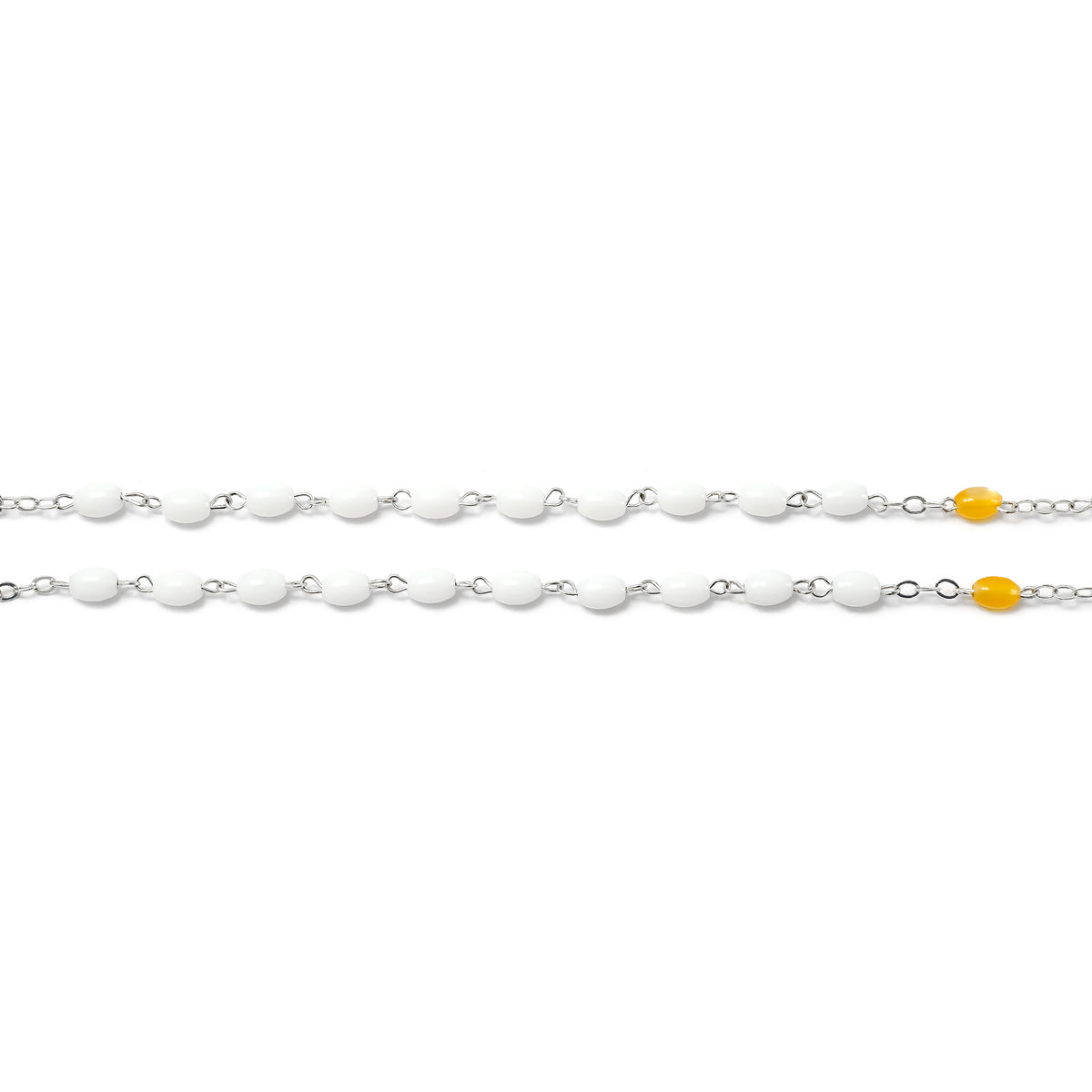 Silver chain with yellow beads on a white background