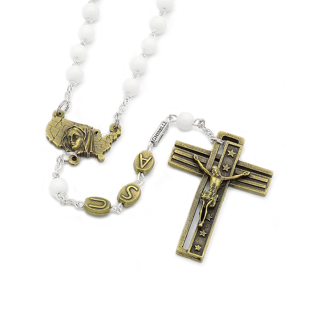 Antique bronze finished rosary with white glass beads, featuring a crucifix with an inscription and a centerpiece with an image of the Immaculate Conception.