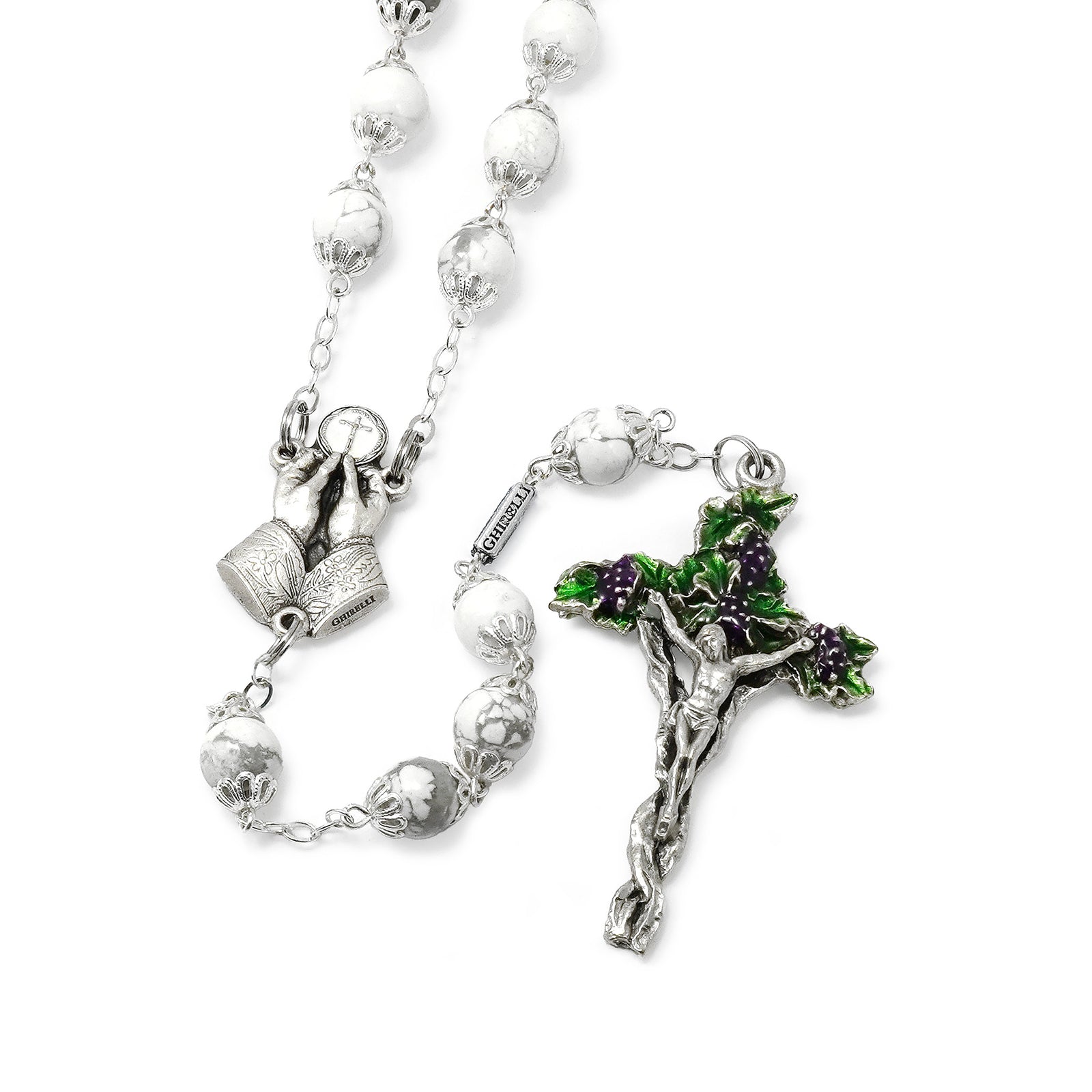 Silver rosary with a crucifix and prayer beads on a white background