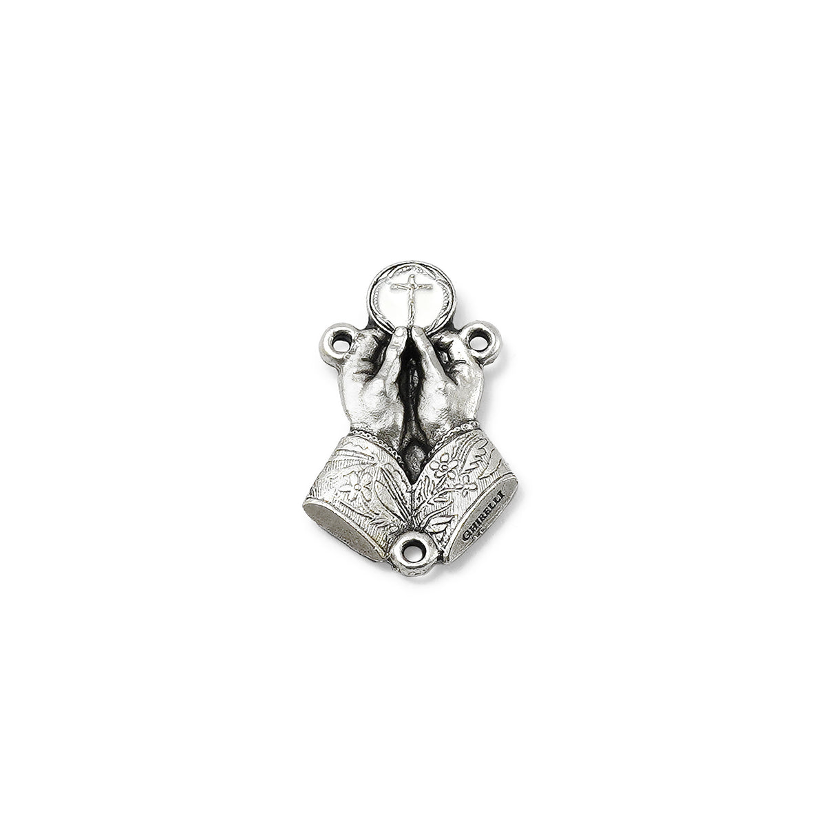 Silver pendant of hands holding a cross on a white background
