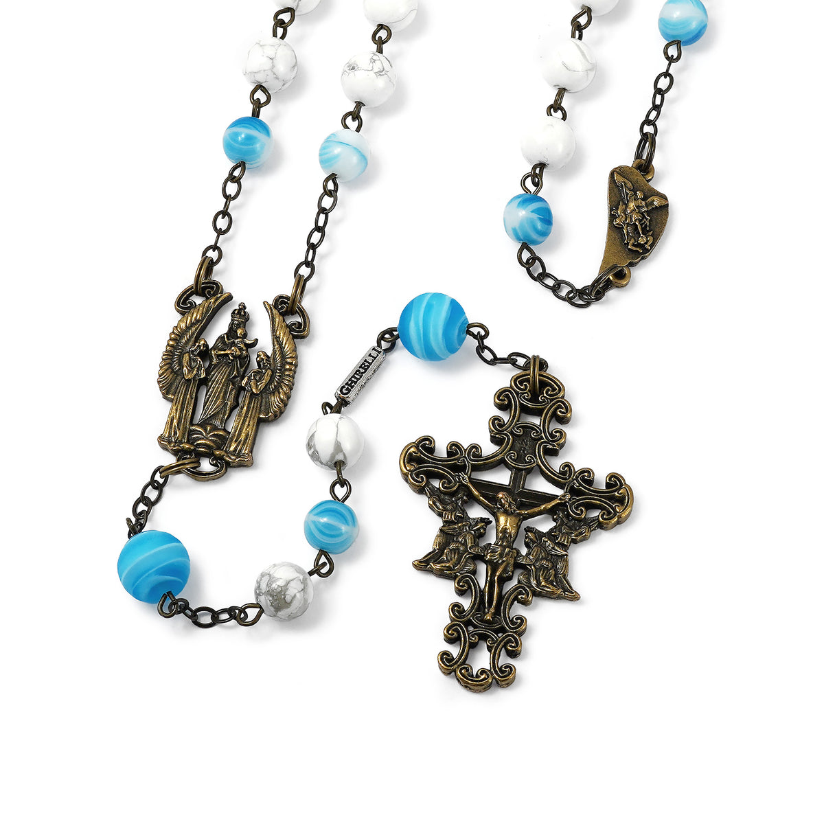Rosary with blue and white beads and ornate metal crucifix and saints on a white background