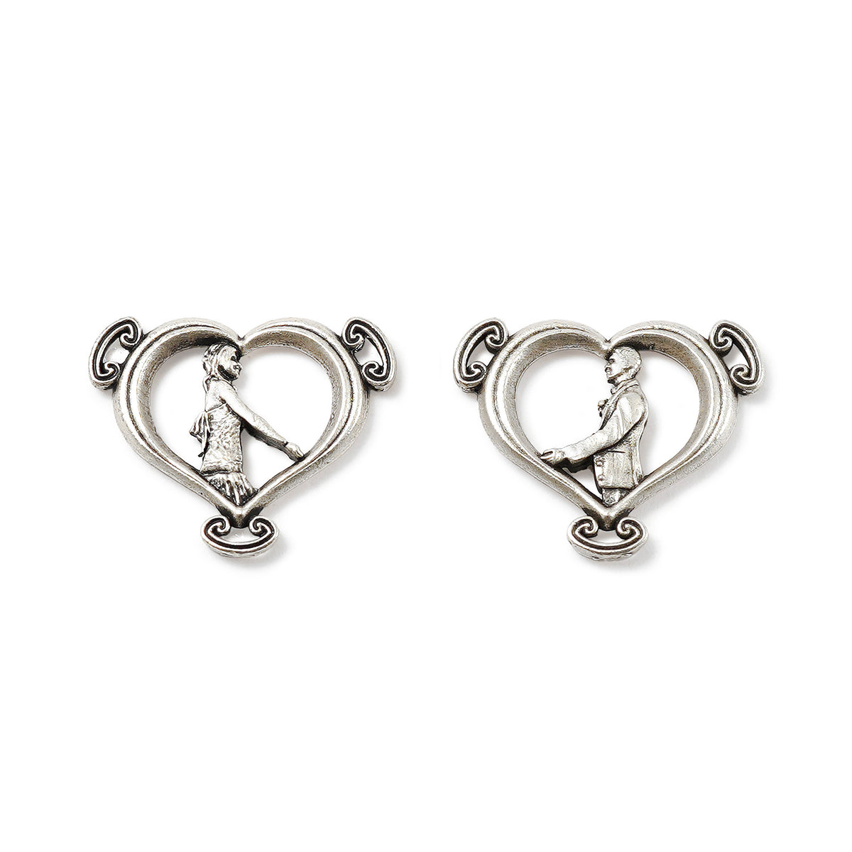 Pair of silver heart-shaped earrings with intricate designs on a white background