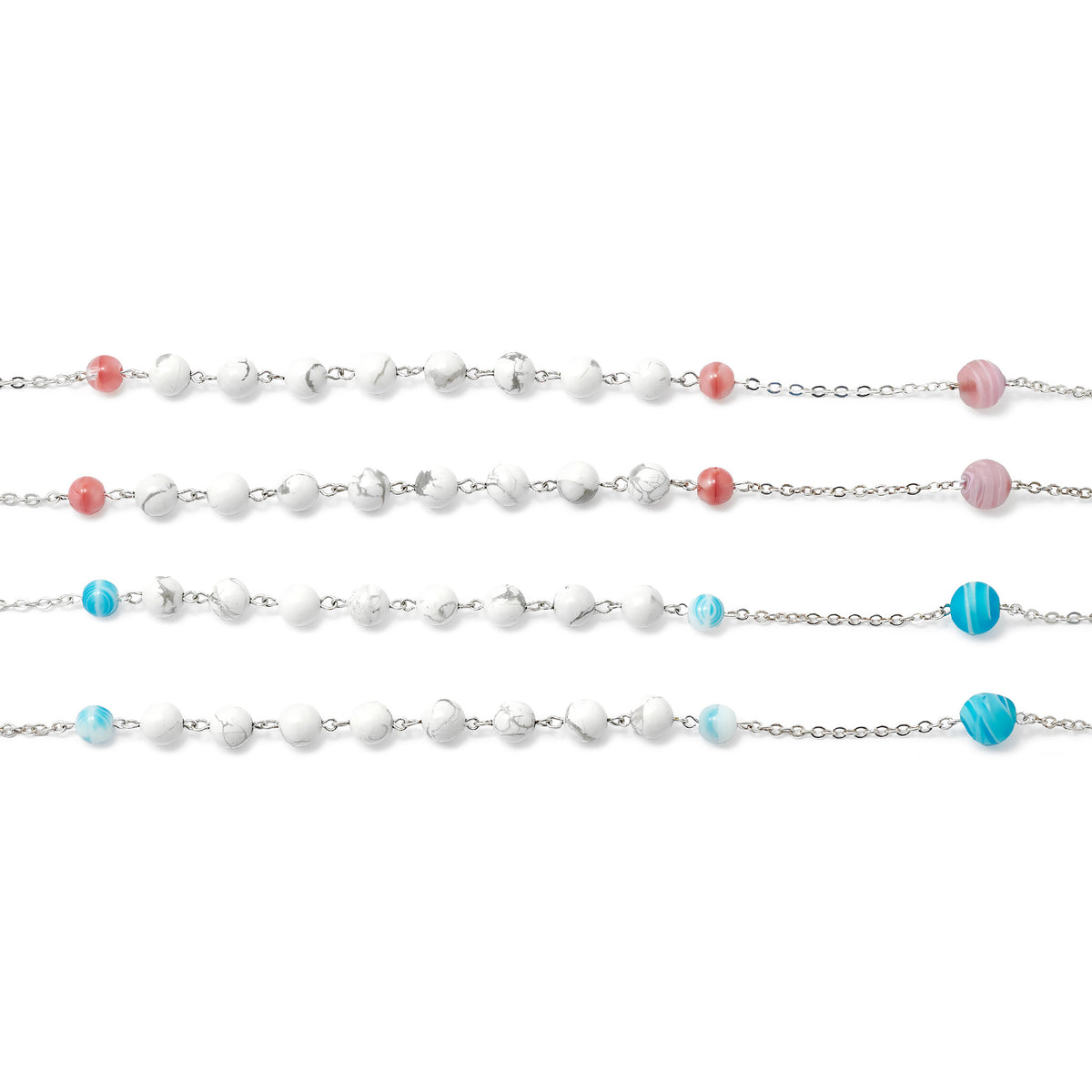 Three pearl necklaces with colored beads on a white background