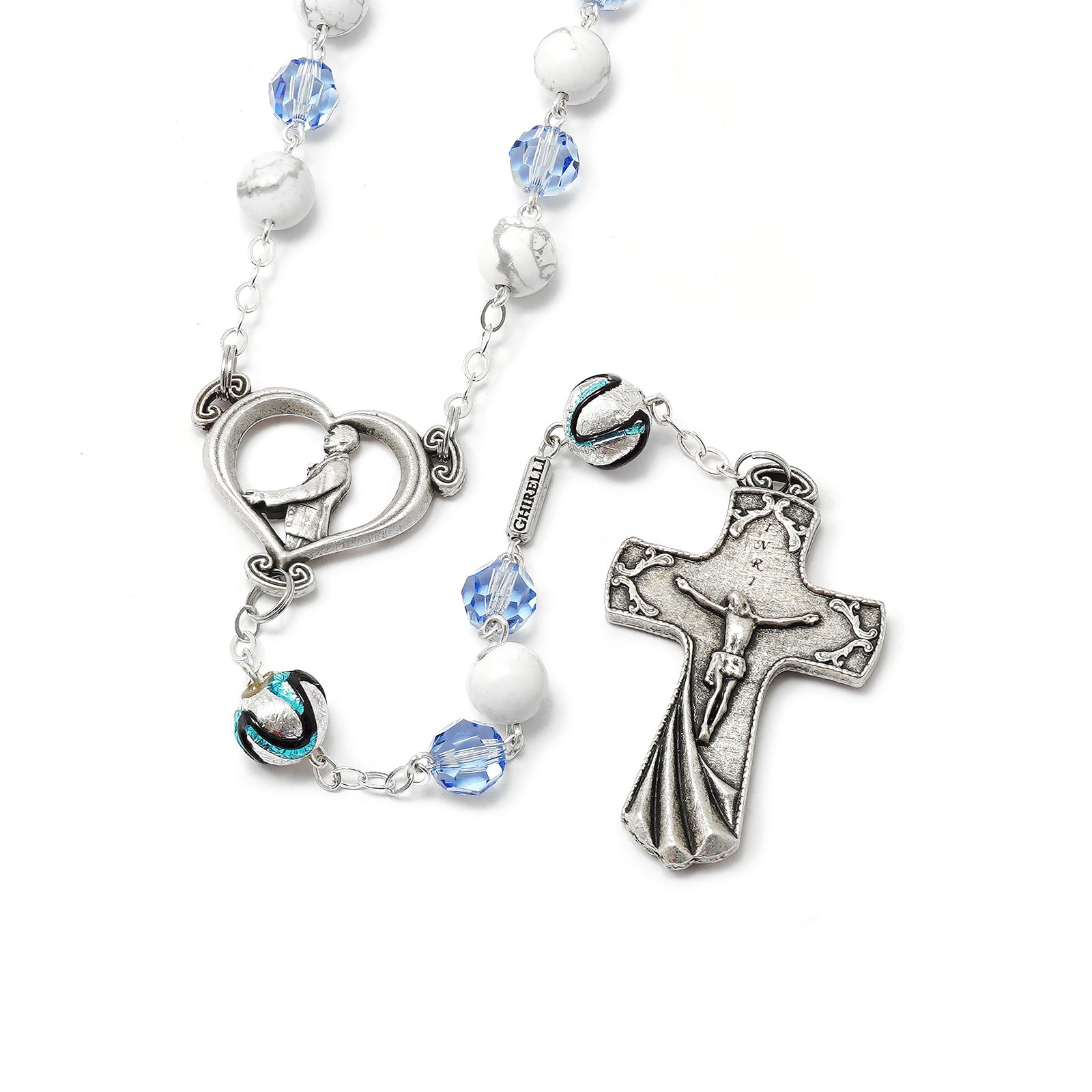 Rosary with cross and heart-shaped charm on a white background