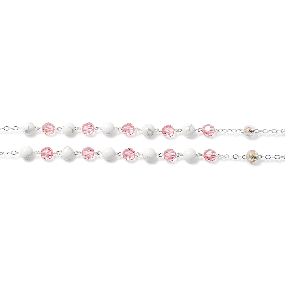 Silver bracelet with pink and clear beads on a white background