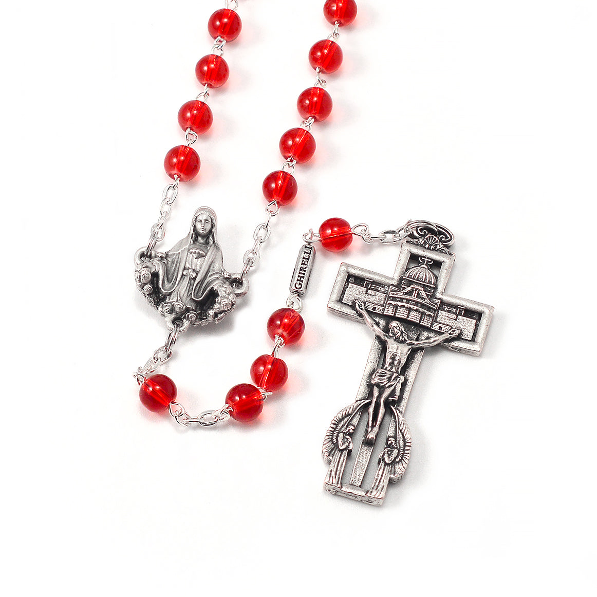 A detailed rosary with red round beads and silver-colored centerpiece and cross, featuring the figure of Mary and Jesus.