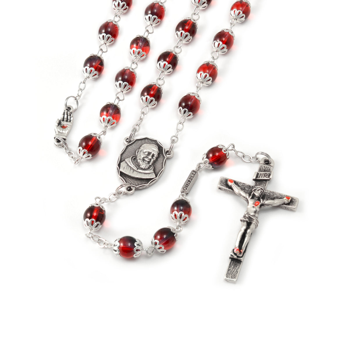 A rosary with red Bohemian glass beads and antique silver caps, featuring an image of Saint Pio on the centerpiece and a special crucifix.